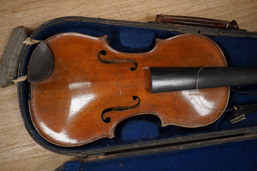 Two cased violins; one French 19th century bearing a hand written label for Francesco Werentle 1746, body length 35.5cm, the other an early 20th century violin, body length 35cm. Condition - poor.